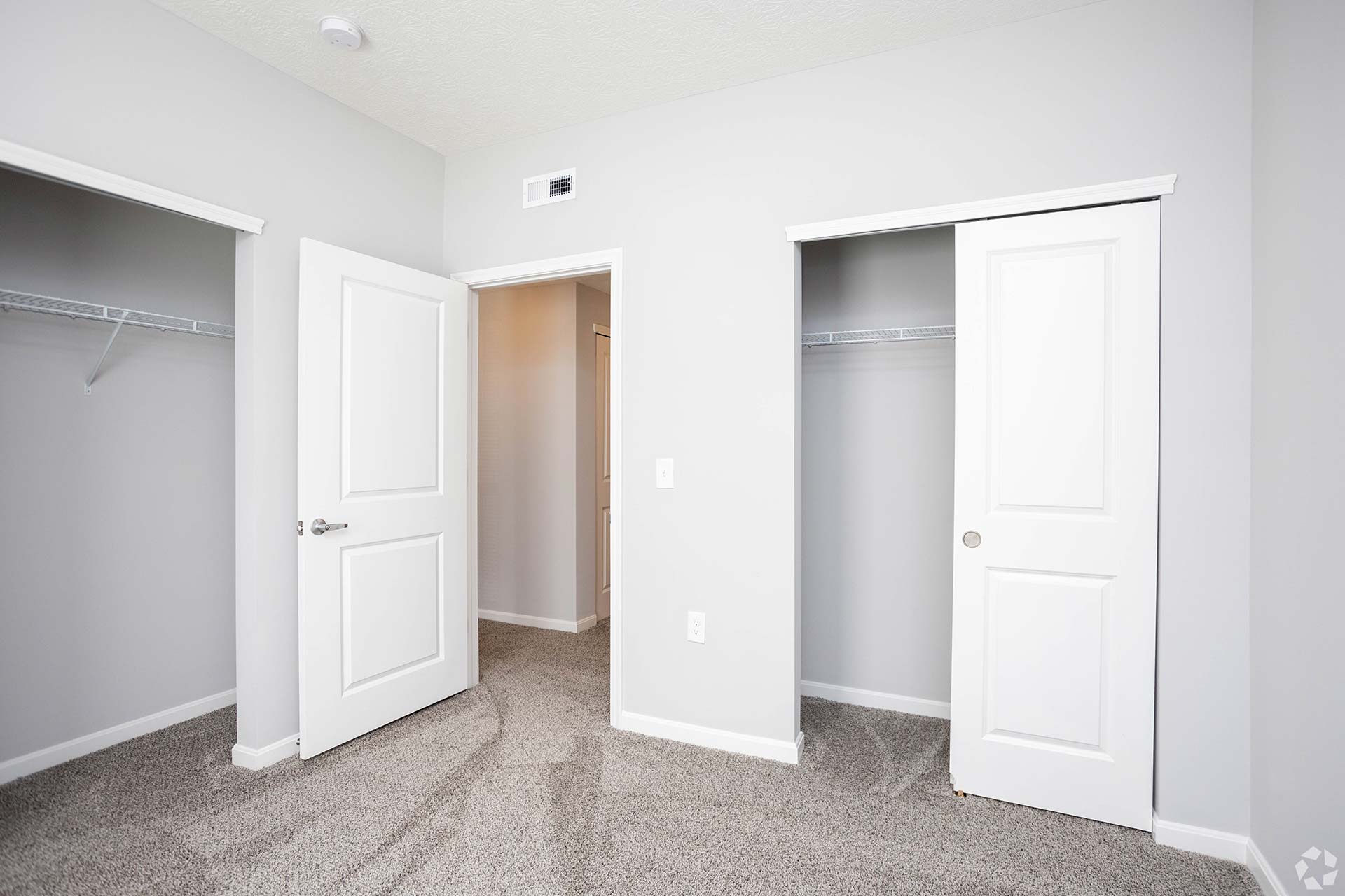 a empty room with two closets and a door at The Adams Pointe