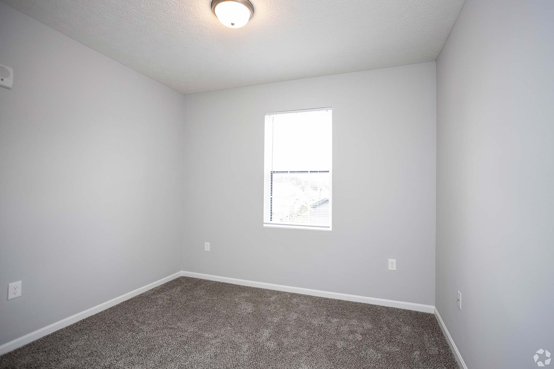 empty room with carpet and window in a house at The Adams Pointe